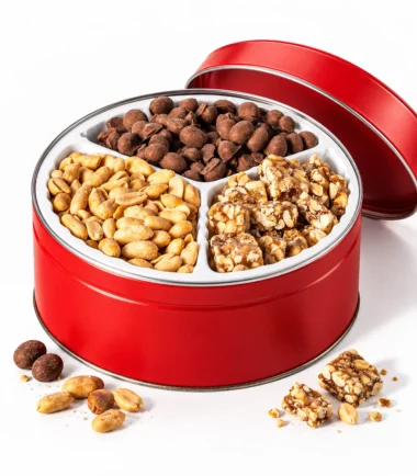 Open Coleman's red 3-way gift tin with cocktail peanuts, chocolate peanuts and peanut candy